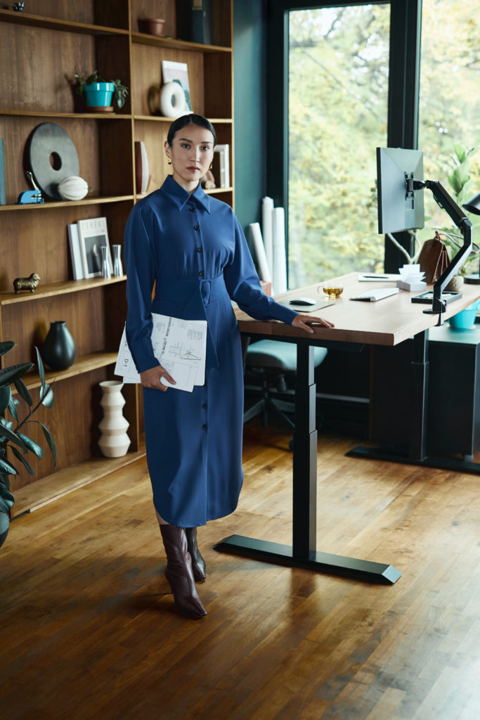 woman standing at desk - work from home fashion