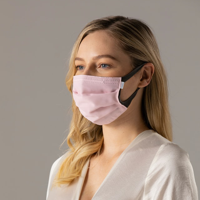 female wearing pink face mask
